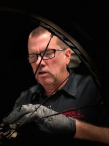 A man working on a motorcycle tire.